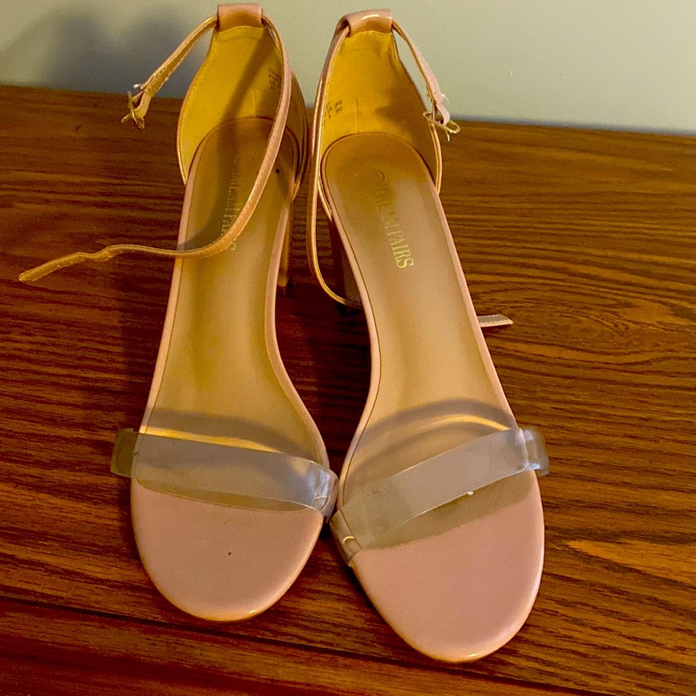 Nude heels with a clear strap.